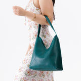 Sea Glass Large | Model wearing petite shoulder bag with adjustable strap and magnetic snap closure