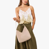 Toasted Oat Large | Model carrying mid-size shoulder bag with magnetic snap closure