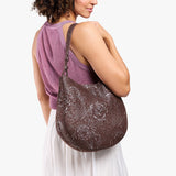 Sepia Large | Model holding round leather purse with adjustable shoulder strap