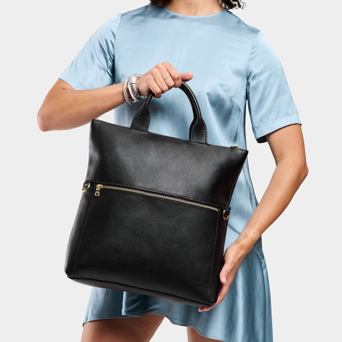 Pebbled--black*Large | Model wearing a convertible tote clutch crossbody