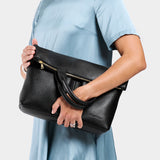 Pebbled--black Large | Model wearing a convertible tote clutch crossbody