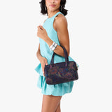 Carnival Large | Model holding mini duffle shaped handbag with crossbody strap