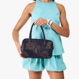 Carnival Large | Model holding mini duffle shaped handbag with crossbody strap