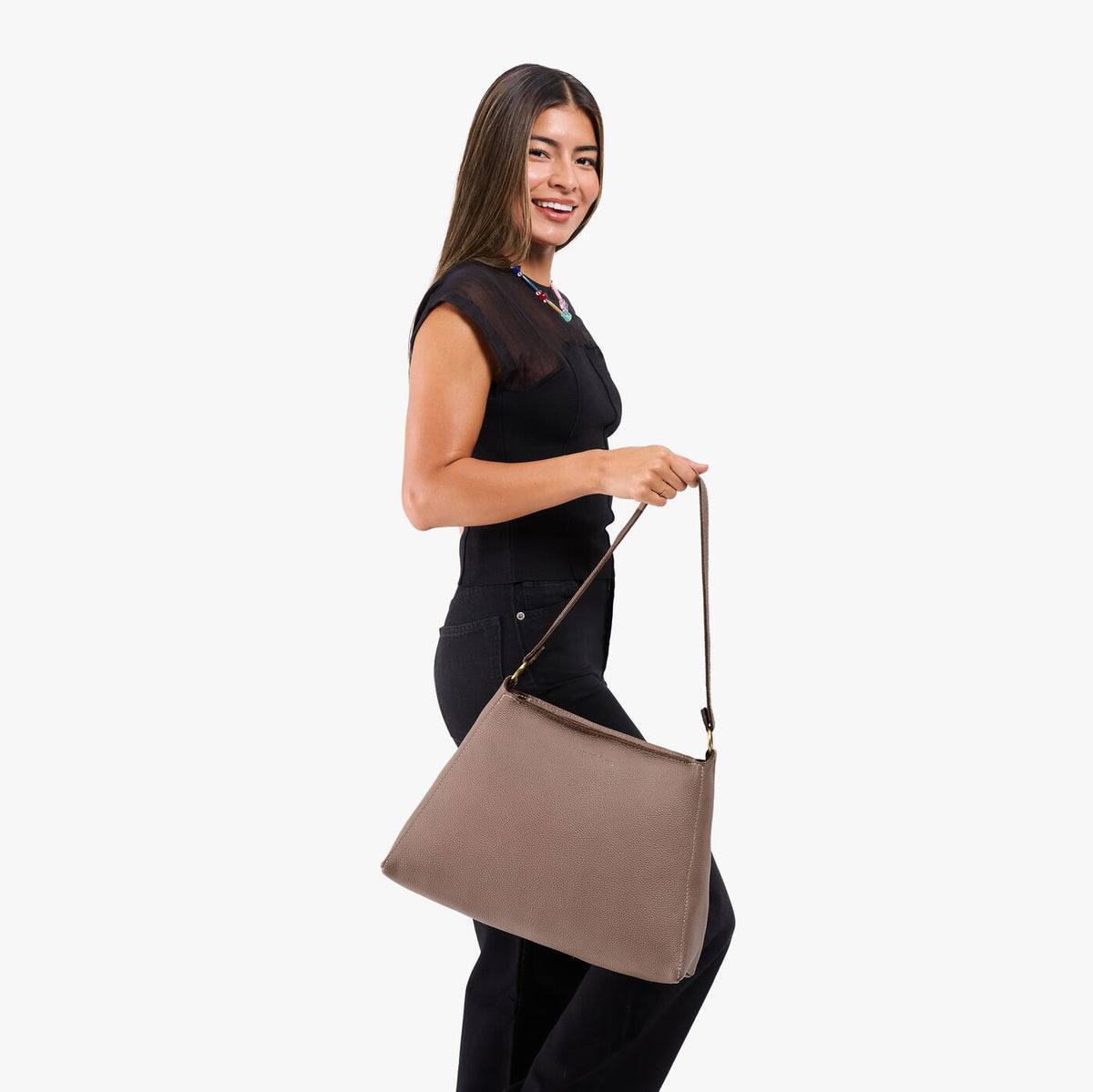 Sparrow*Large | Model holding a triangular shoulder bag with antiqued brass finished 