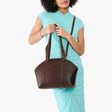 Coldbrew Large | Model holding a half circle crossbody bag with handles and removable crossbody strap 