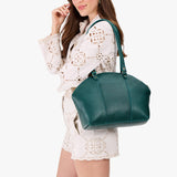 Sea Glass Large | Model holding a half circle crossbody bag with handles and removable crossbody strap