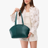 Sea Glass Large | Model holding a half circle crossbody bag with handles and removable crossbody strap