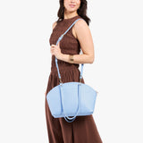 All Variants | Model carrying Logan Crossbody Bag in Skyway