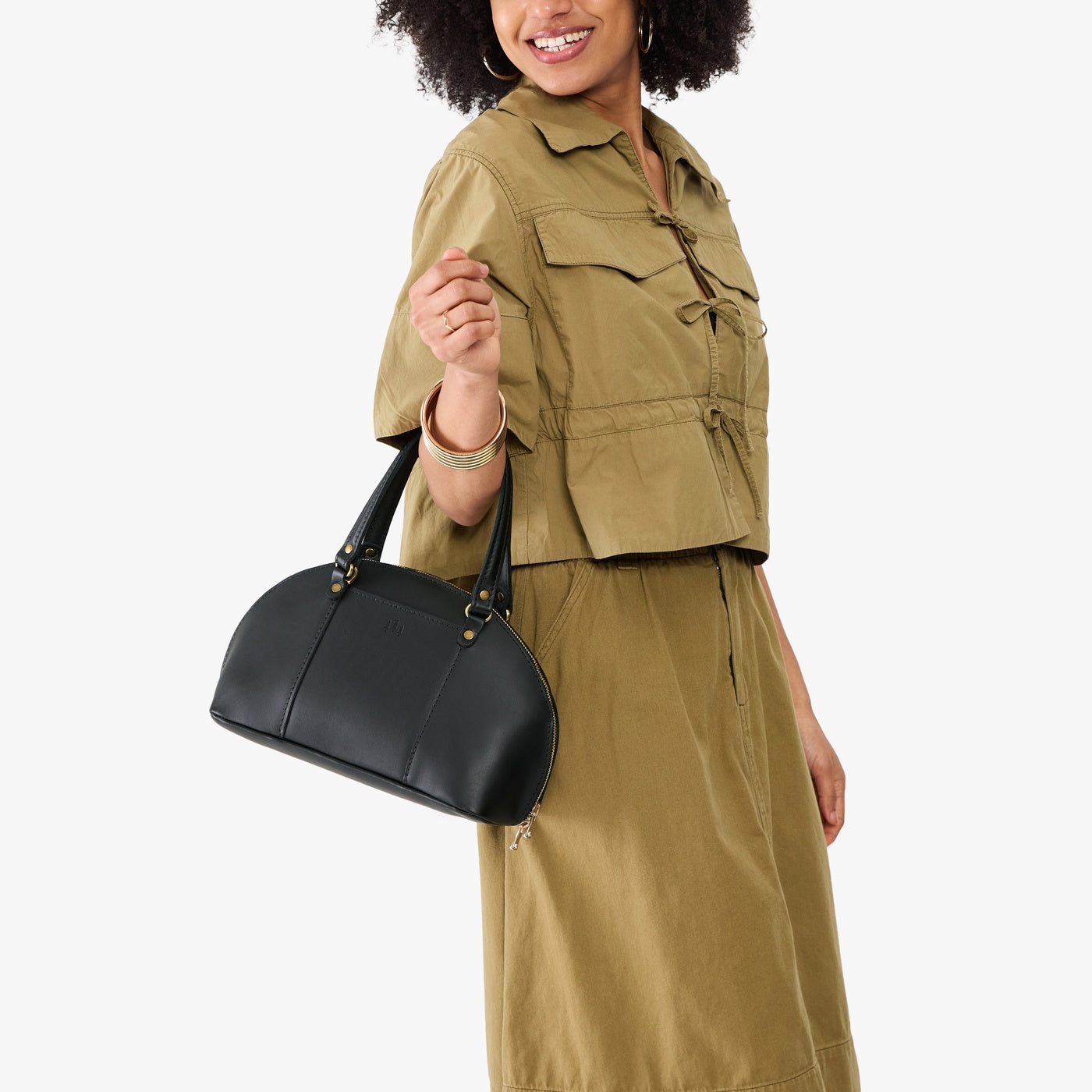 Black*Small | Model holding a half circle crossbody bag with handles and removable crossbody strap 