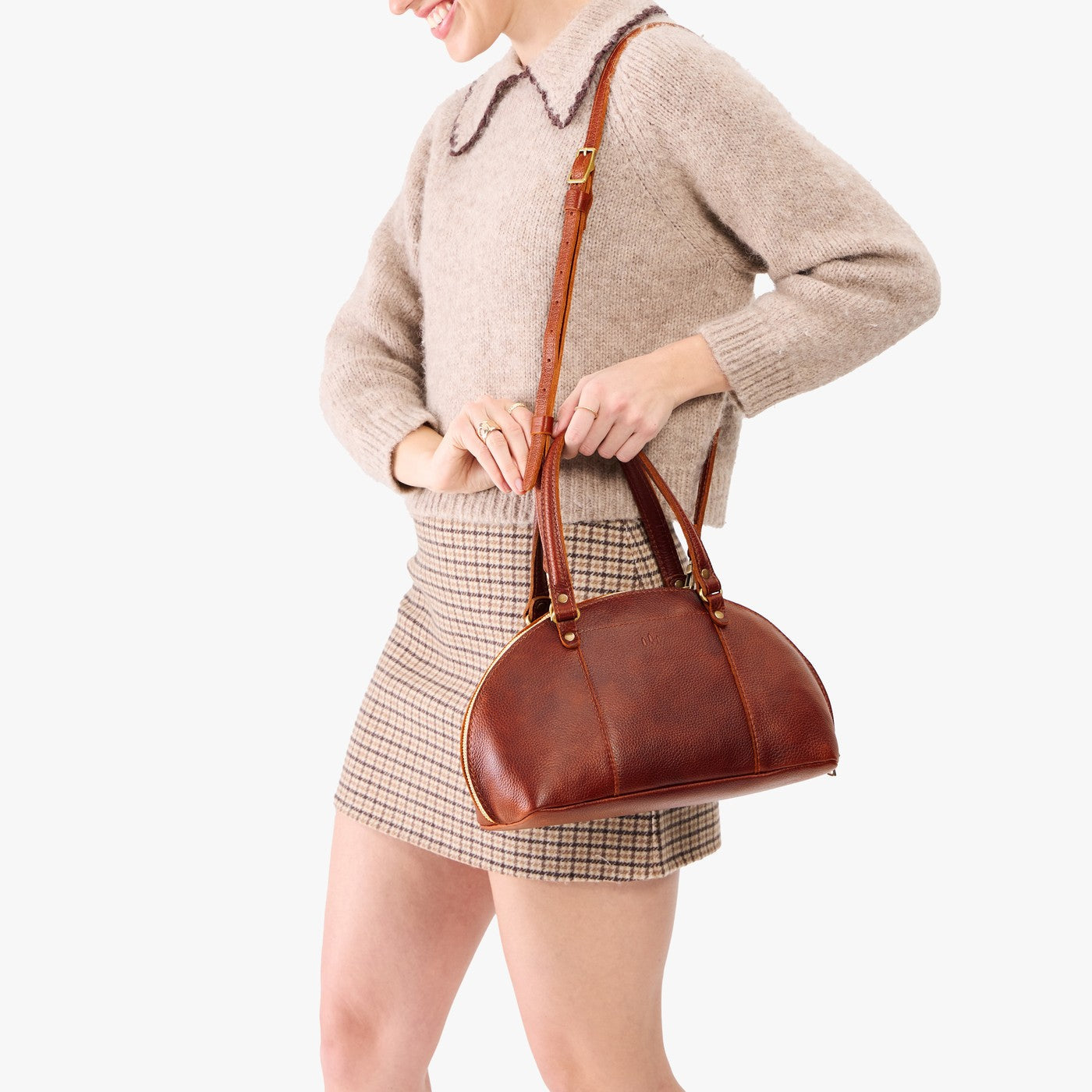 Nutmeg*Small | Model holding a half circle crossbody bag with handles and removable crossbody strap 