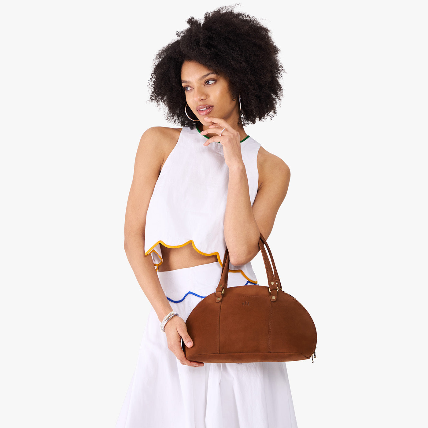 Wildwood*Small | Model holding a half circle crossbody bag with handles and removable crossbody strap