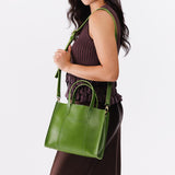 Green Apple | Model wearing structured mid-size tote bag with overlapping panels and crossbody strap