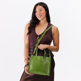 Green Apple | Model wearing structured mid-size tote bag with overlapping panels and crossbody strap