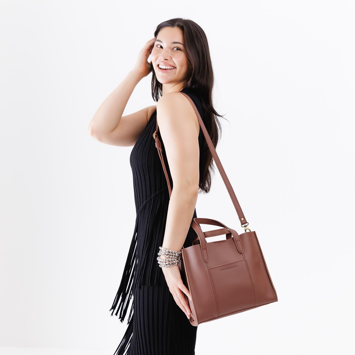 Sunkissed | Model wearing structured mid-size tote bag with overlapping panels and crossbody strap