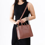 Sunkissed | Model wearing structured mid-size tote bag with overlapping panels and crossbody strap