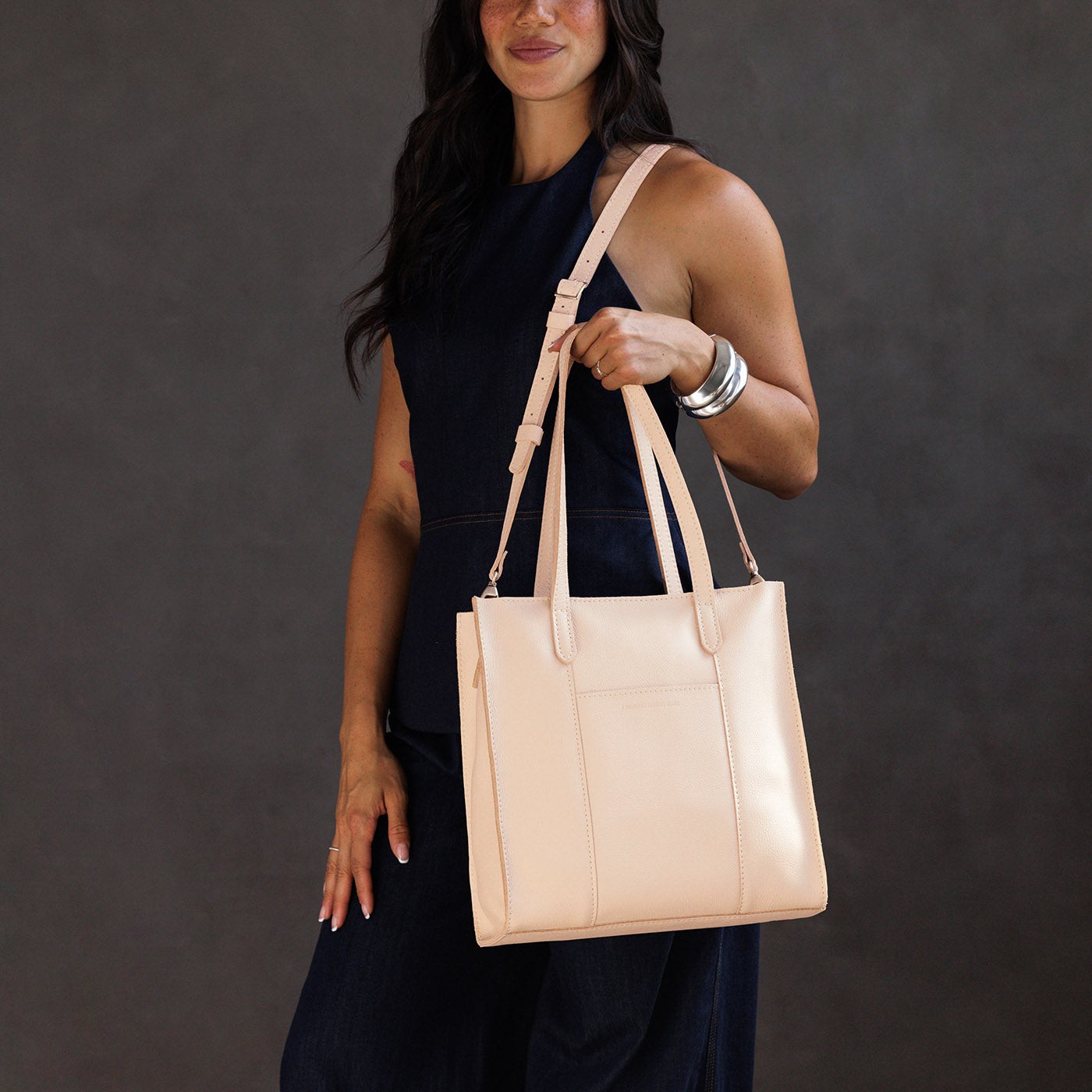 Moonflower*North/South | Model wearing structured large tote bag with overlapping panels and crossbody strap