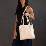 Moonflower North/South | Model wearing structured large tote bag with overlapping panels and crossbody strap