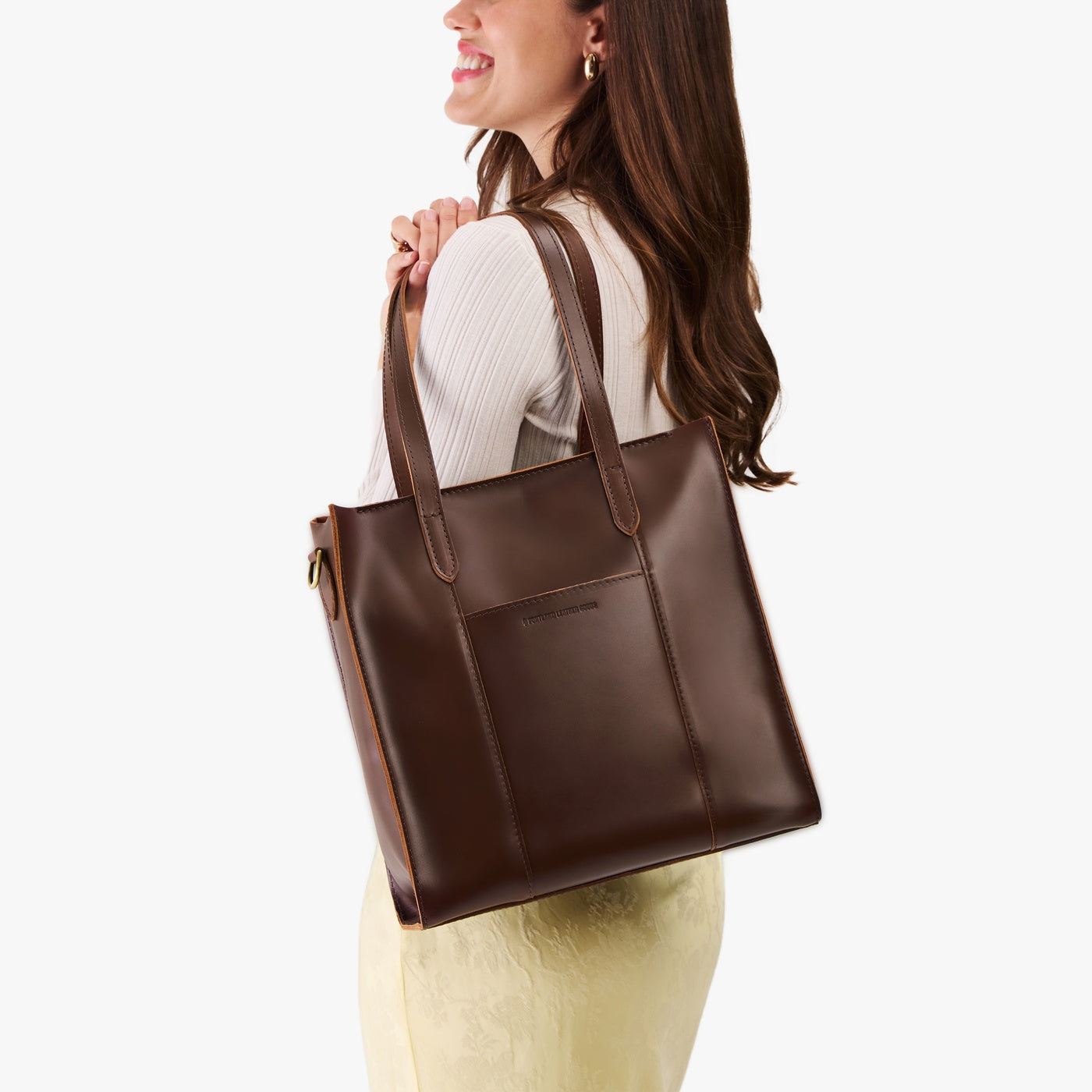 Chocolate Brown*North/South | Model wearing structured large tote bag with overlapping panels and crossbody strap