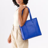 Astro Blue North/South | Model wearing structured large tote bag with overlapping panels and crossbody strap