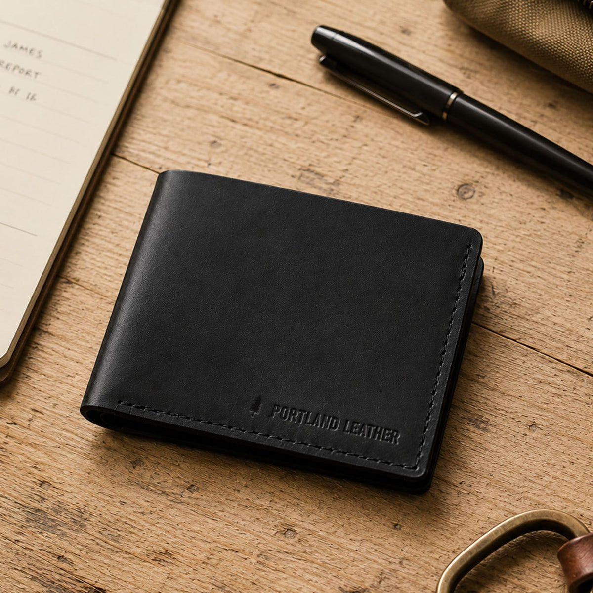 Nero | A leather bifold wallet with visible stitching and an embossed 'PORTLAND LEATHER' logo