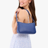 Molino Blue | Model carrying petite bean shaped shoulder bag with a zipper closure