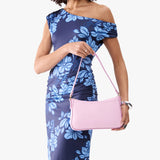 Pinkaboo | Model holding petite bean shaped shoulder bag with a zipper closure