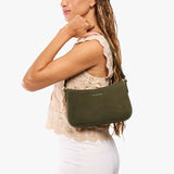 Verdant Small | Model carrying petite bean shaped shoulder bag with a zipper closure