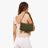 Verdant Small | Model carrying petite bean shaped shoulder bag with a zipper closure