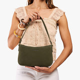 Verdant Small | Model carrying petite bean shaped shoulder bag with a zipper closure