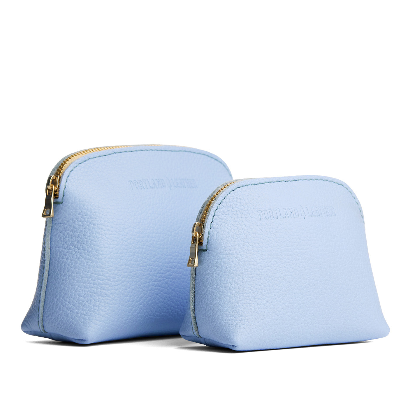 Skyway | Comparison view of compact leather pouches with top zippers