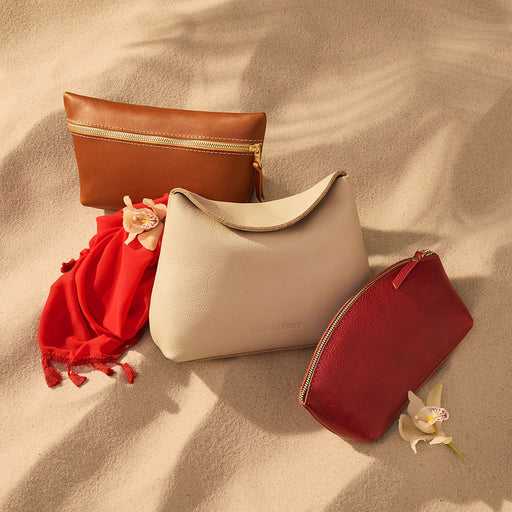 Group of leather pouches on sand featured image