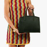 Evergreen Medium | Model carrying leather tote bag with handles, adjustable crossbody strap, and two back pockets