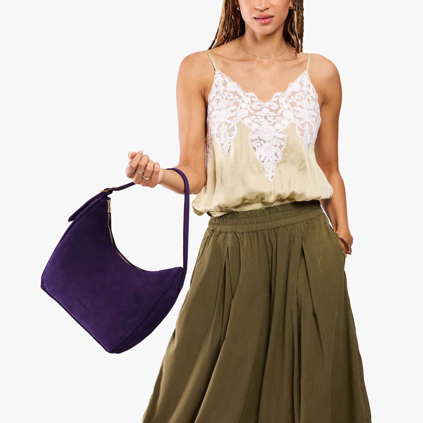 Imperial*Medium | Model holding u-shaped, flat-bottomed leather shoulder bag with adjustable strap