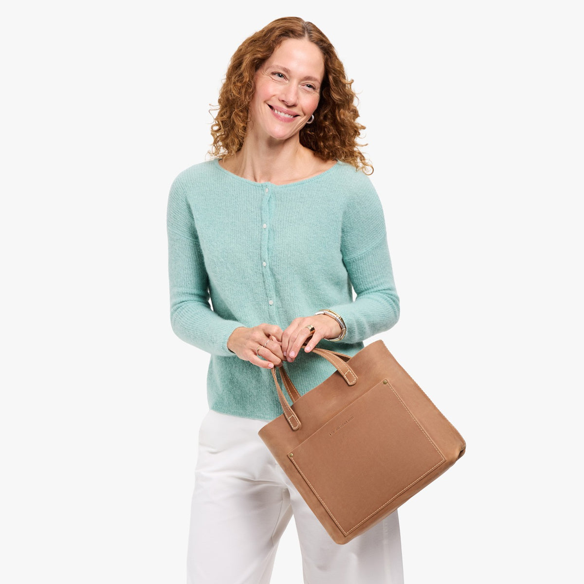 Rodeo | Model wearing a midsize crossbody tote with handles and a front pocket