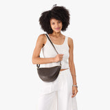 Grizzly Medium | Model wearing petite half circle shaped sling bag