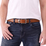Pecan Amber | A person wearing the Italian Reversible Leather Belt on the pebbled black side