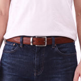 Pecan Amber | A person wearing the Italian Reversible Leather Belt on the pebbled black side
