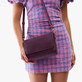 Plum Medium | Model Wearing Small Leather Crossbody Bag with Magnetic Messenger Bag Closure