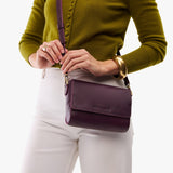 Plum Mini | Model Wearing Small Leather Crossbody Bag with Magnetic Messenger Bag Closure