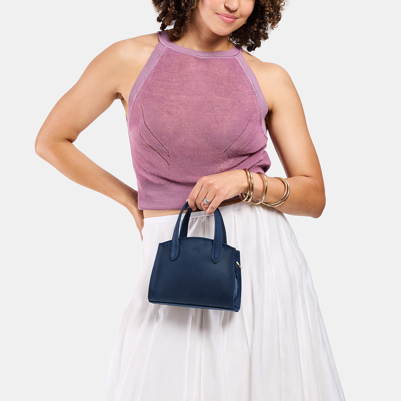 Deep Water*Mini | Model carrying small leather tote bag with handles, adjustable crossbody strap, and one back pocket