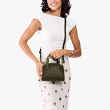 Pebbled Olive Mini | Model carrying small leather tote bag with handles, adjustable crossbody strap, and one back pocket