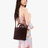 Velvet Brown Classic | Model carrying crossbody tote bag with snap closure and front pocket