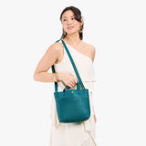 Aquarius Classic | Model holding crossbody tote bag with snap closure and front pocket