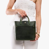 Evergreen Classic | Model carrying crossbody tote bag with snap closure and front pocket
