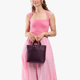 Larkspur Classic | Model carrying crossbody tote bag with snap closure and front pocket