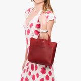 Phoenix Classic | Model holding crossbody tote bag with snap closure and front pocket