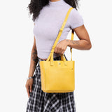 Pomello Classic | Model wearing crossbody tote bag with snap closure and front pocket