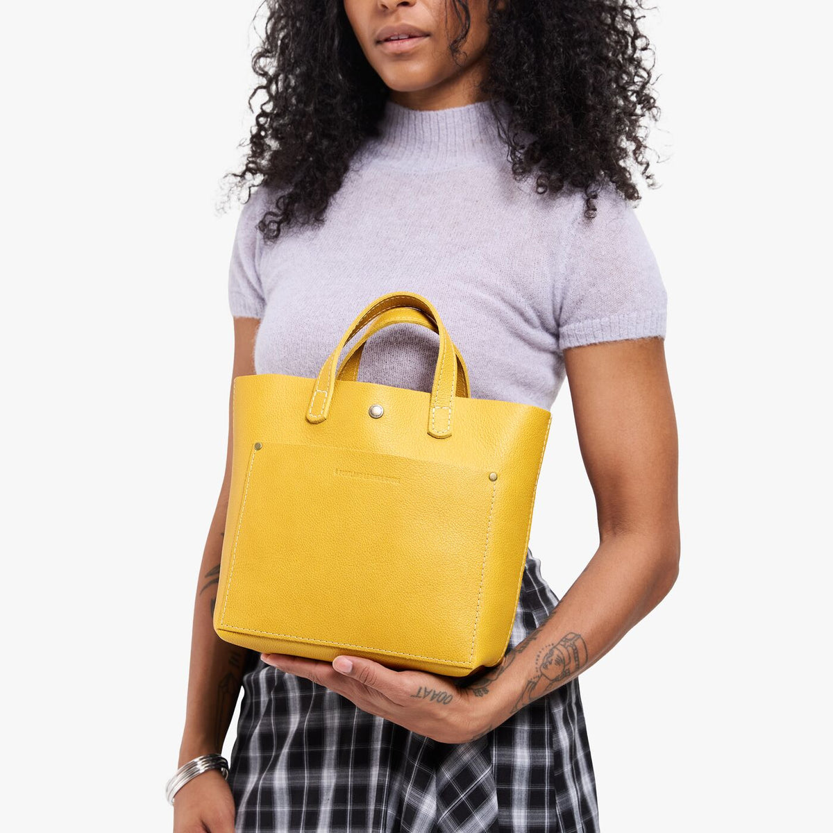 Pomello*Classic | Model wearing crossbody tote bag with snap closure and front pocket
