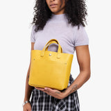 Pomello Classic | Model wearing crossbody tote bag with snap closure and front pocket