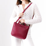 Berry Good Zipper | Model holding crossbody tote bag with zipper closure and front pocket
